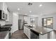 Kitchen with stainless steel appliances, a kitchen island and white cabinetry at 1656 Desert Path Ave, North Las Vegas, NV 89032