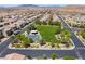 A beautiful aerial view of a neighborhood park with a playground and lush green grass at 184 Cullerton St, Las Vegas, NV 89148
