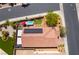 Overhead shot of backyard with covered patio, outdoor kitchen, solar panels, and spa in residential neighborhood at 184 Cullerton St, Las Vegas, NV 89148
