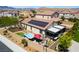 An aerial view of the backyard features a spa, patio, and solar panels on this well kept property at 184 Cullerton St, Las Vegas, NV 89148