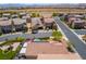 Aerial view of backyard featuring solar panels, spa, patio, desert landscaping, and mountain views at 184 Cullerton St, Las Vegas, NV 89148