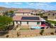 An aerial view showcasing a home with a patio, pool, and solar panels surrounded by desert landscaping at 184 Cullerton St, Las Vegas, NV 89148