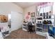 Bright bedroom featuring a desk with shelving, a closet with sliding doors, and neutral color carpet at 184 Cullerton St, Las Vegas, NV 89148