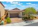 Attractive single-story home featuring a brick driveway, two-car garage, and desert-friendly landscaping at 184 Cullerton St, Las Vegas, NV 89148