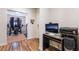 Bright home office featuring wood floors, desk setup, and exercise equipment in an adjacent room at 184 Cullerton St, Las Vegas, NV 89148