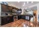 Modern kitchen featuring dark cabinetry, stainless steel appliances, granite countertops, and hardwood floors at 184 Cullerton St, Las Vegas, NV 89148