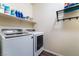 A dedicated laundry room featuring a modern Samsung washer and dryer, shelves and a towel rack at 184 Cullerton St, Las Vegas, NV 89148