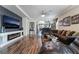 Open-concept living room with hardwood floors, a modern fireplace, and stylish furnishings offer a cozy atmosphere at 184 Cullerton St, Las Vegas, NV 89148