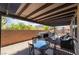 Covered patio featuring an outdoor kitchen and bar, plus outdoor furniture and table for seating at 184 Cullerton St, Las Vegas, NV 89148