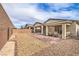 Backyard with brick pavers, gravel landscaping, and covered patio seating at 2114 Thelen Ave, North Las Vegas, NV 89086