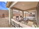 Covered patio and backyard features comfortable seating and outdoor cooking area at 2114 Thelen Ave, North Las Vegas, NV 89086