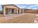 Backyard with brick pavers, gravel landscaping, and covered patio with grill at 2114 Thelen Ave, North Las Vegas, NV 89086