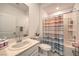 Bathroom features a shower/tub combination with a shower curtain, toilet and sink at 2114 Thelen Ave, North Las Vegas, NV 89086