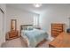 Cozy bedroom with a comfortable bed, wooden furniture and bright natural light at 2114 Thelen Ave, North Las Vegas, NV 89086