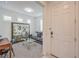 Cozy entryway featuring a gray couch, decorative screen, desk, and a glass coffee table, offering a welcoming space at 2114 Thelen Ave, North Las Vegas, NV 89086