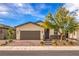 Charming single-story home with a well-manicured lawn, brick driveway, and a two-car garage at 2114 Thelen Ave, North Las Vegas, NV 89086