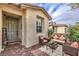 Inviting front porch with a seating area, welcome mat, and desert landscaping around the home's exterior at 2114 Thelen Ave, North Las Vegas, NV 89086