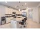 Modern kitchen with white cabinets, granite countertops, stainless steel appliances, and a central island with bar seating at 2114 Thelen Ave, North Las Vegas, NV 89086
