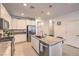 A modern kitchen features stainless steel appliances, granite counters, and white cabinetry at 2114 Thelen Ave, North Las Vegas, NV 89086