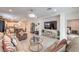 Bright living room featuring neutral walls, tile floors, modern decor, and views of the kitchen and dining area at 2114 Thelen Ave, North Las Vegas, NV 89086
