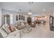 Spacious living area with tile floors, recessed lighting, plantation shutters, and an open layout to the kitchen at 2114 Thelen Ave, North Las Vegas, NV 89086
