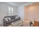 Cozy living room with a grey sofa, decorative pillows, and a window with shutters at 2114 Thelen Ave, North Las Vegas, NV 89086
