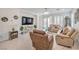 Comfortable living room featuring tile floors, recessed lighting, and a sliding glass door to the backyard at 2114 Thelen Ave, North Las Vegas, NV 89086