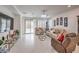 Bright living room with tile floors, recessed lights, and a view of the backyard through a sliding glass door at 2114 Thelen Ave, North Las Vegas, NV 89086