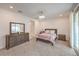 A lovely main bedroom with carpet, natural light, a ceiling fan and a matching furniture set at 2114 Thelen Ave, North Las Vegas, NV 89086