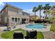 Backyard features a private pool, spa, outdoor kitchen and lounge seating at 2117 Mountain Rail Dr, North Las Vegas, NV 89084