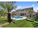 Backyard with a sparkling pool, hot tub, and well-manicured landscaping at 2117 Mountain Rail Dr, North Las Vegas, NV 89084