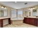Bright bathroom features double vanity, soaking tub and stand-alone vanity at 2117 Mountain Rail Dr, North Las Vegas, NV 89084