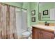 Bathroom with shower and tub combination, a dark vanity with a beige countertop and light green walls at 2117 Mountain Rail Dr, North Las Vegas, NV 89084