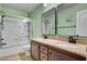 Bathroom features a dual sink vanity and a glass-enclosed shower/tub at 2117 Mountain Rail Dr, North Las Vegas, NV 89084