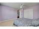 Purple bedroom featuring carpeted floors, closet and ceiling fan at 2117 Mountain Rail Dr, North Las Vegas, NV 89084