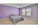 Purple bedroom featuring carpeted floors and a ceiling fan at 2117 Mountain Rail Dr, North Las Vegas, NV 89084