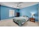 Blue bedroom with carpeted floors, ceiling fan and side table with lamp at 2117 Mountain Rail Dr, North Las Vegas, NV 89084