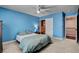 Blue bedroom with carpeted floors, closet and ceiling fan at 2117 Mountain Rail Dr, North Las Vegas, NV 89084