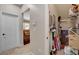 Hallway featuring a utility closet packed with cleaning and home supplies with a view into the living room at 2117 Mountain Rail Dr, North Las Vegas, NV 89084