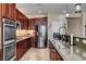 Gourmet kitchen features stainless steel appliances and rich wood cabinetry at 2117 Mountain Rail Dr, North Las Vegas, NV 89084