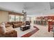 Expansive living room open to the kitchen with comfortable seating, hardwood floors, and a ceiling fan at 2117 Mountain Rail Dr, North Las Vegas, NV 89084