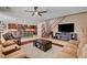 Open concept living room featuring a kitchen island, a staircase, hardwood floors, and comfortable seating at 2117 Mountain Rail Dr, North Las Vegas, NV 89084