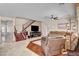 Inviting living room with hardwood flooring, a staircase, a large TV, and comfortable seating at 2117 Mountain Rail Dr, North Las Vegas, NV 89084
