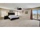 Large primary bedroom with ceiling fan, access to outdoor patio, and view of mountains at 2117 Mountain Rail Dr, North Las Vegas, NV 89084