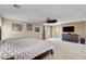 Spacious primary bedroom featuring a ceiling fan, neutral carpet, and sliding glass door for patio access at 2117 Mountain Rail Dr, North Las Vegas, NV 89084