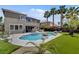 Backyard view of a private pool, spa, lounge chairs, and palm trees at 2117 Mountain Rail Dr, North Las Vegas, NV 89084