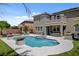 A gorgeous backyard pool and spa with an outdoor kitchen and covered patio create an entertainer's dream at 2117 Mountain Rail Dr, North Las Vegas, NV 89084