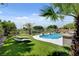 A view of the beautiful pool and spacious green backyard at 2117 Mountain Rail Dr, North Las Vegas, NV 89084