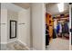Walk-in closet with wood-look tile, access to the primary bath and a full-length mirror at 2117 Mountain Rail Dr, North Las Vegas, NV 89084