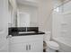 Updated bathroom featuring a vanity with a black granite countertop and a tub at 2130 Revere St, North Las Vegas, NV 89030